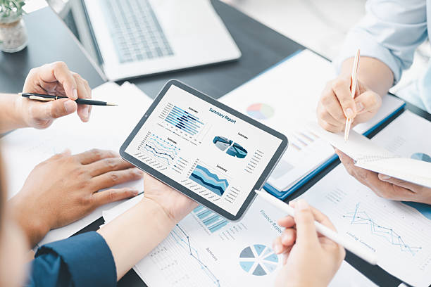 istock Business data analysis concept with colleagues reviewing financial report on tablet, pointing at chart with growth graph, teamwork discussing statistics, planning strategy and corporate success. 2238481786