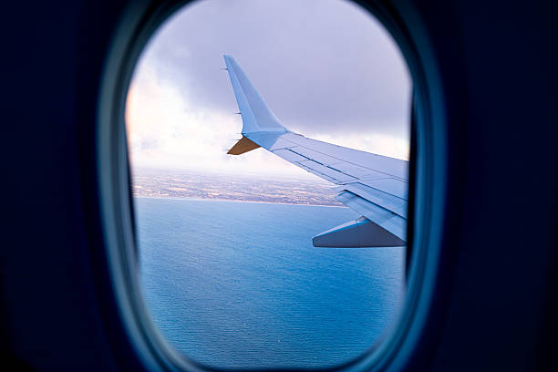 istock Airplane wing flying over Danish coast, Scandinavian landscape from air. 2238481928