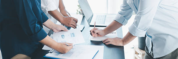 istock Panorama of corporate teamwork with people discussing financial reports, pointing at charts, planning business strategy, analyzing data and collaborating in office meeting for professional success. 2238481993