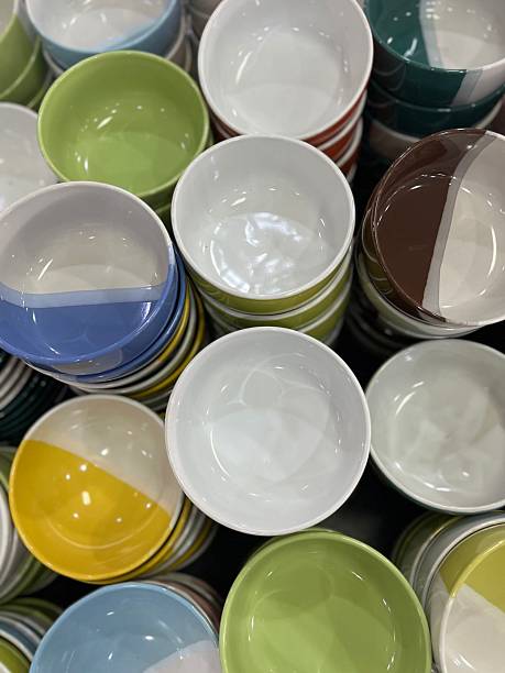istock Top view of stacked ceramic bowls in assorted colors and designs, displayed in a store. 2238484297