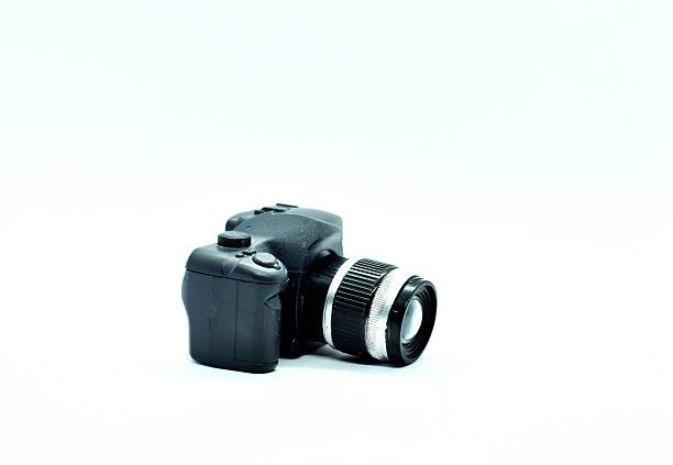 An old silver compact digital camera on white background