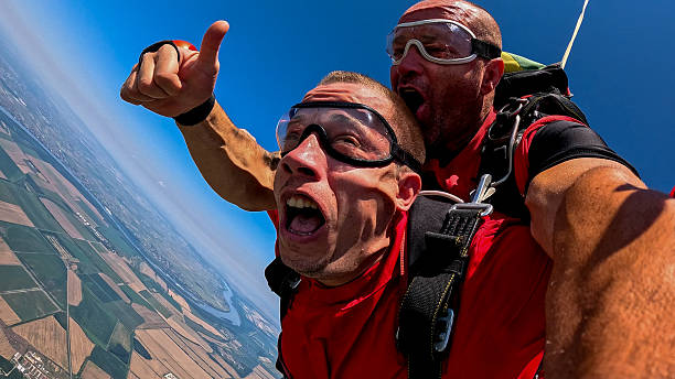 istock Adrenaline fueled tandem skydiving selfie during freefall with instructor and passenger, high speed experience 2238486539