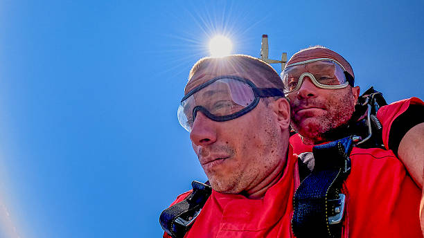 istock Tandem skydivers take a selfie during freefall with wrist camera against a blue sky 2238486743