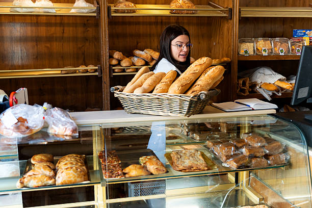 istock Woman working in local traditional bakery selling fresh bread 2238486840