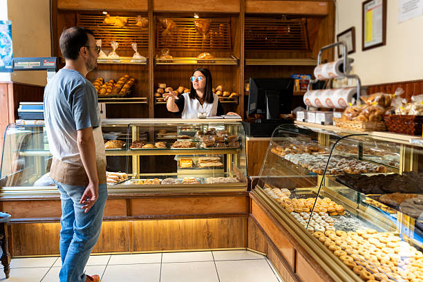 istock Customer buying pastry from employee in bakery 2238486905