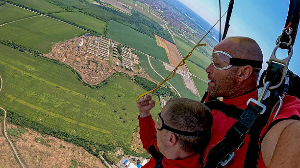 istock Two tandem skydivers take a selfie during freefall with panoramic landscape below 2238486954