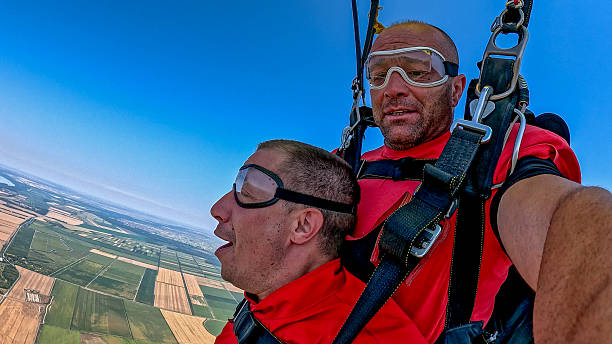 istock Two tandem skydivers selfie during freefall with wrist camera and breathtaking earth view 2238487254