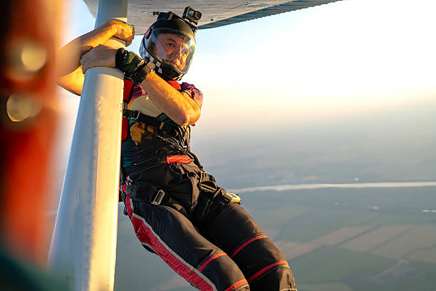 istock Skydiver on aircraft wing prepares for an acrobatic exit during golden hour show jump 2238487298