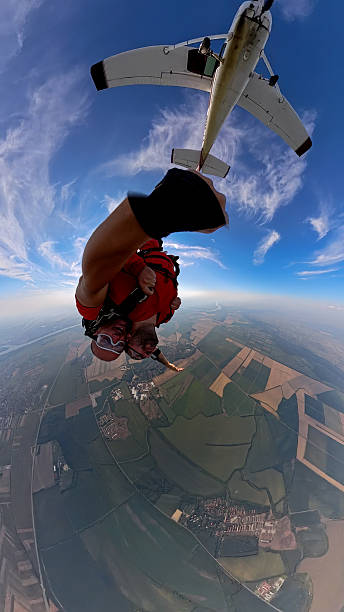 istock Tandem skydiving selfie during freefall with landscape below and aircraft in frame 2238487432