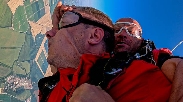 istock Tandem skydivers selfie during freefall with wrist camera and dramatic earth view 2238487614