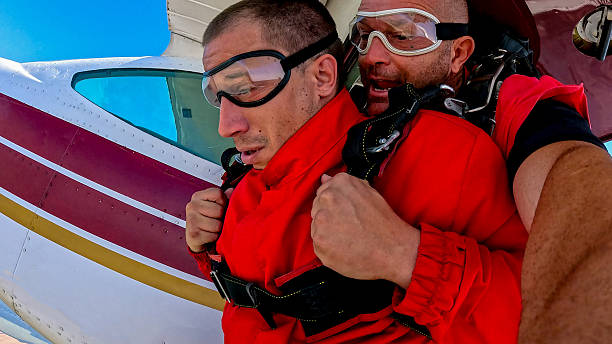 istock Tandem skydiving selfie during freefall captured with wrist camera and safety gear 2238487730