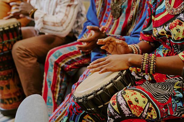 istock Black Adults Celebrating Kwanzaa by Playing Drums and Clapping Hands 2238488072