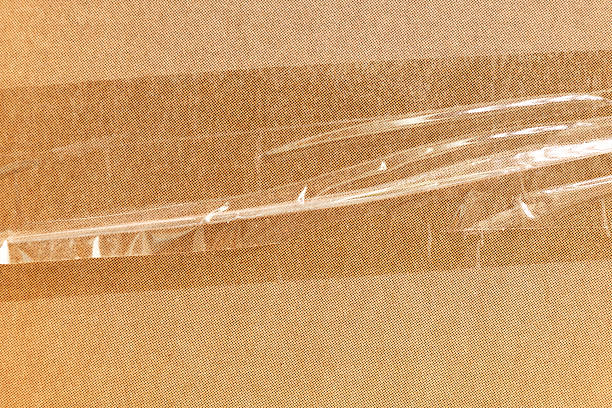 Textured cardboard background with scratches. Abstract cardboard with circles and tape.
