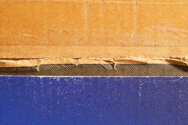 Old textured cardboard surfaces showing various colours and patterns.