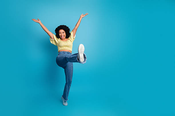 istock Excited young multiethnic woman posing playfully against a blue background showing a gesture of happiness and joy 2238489868