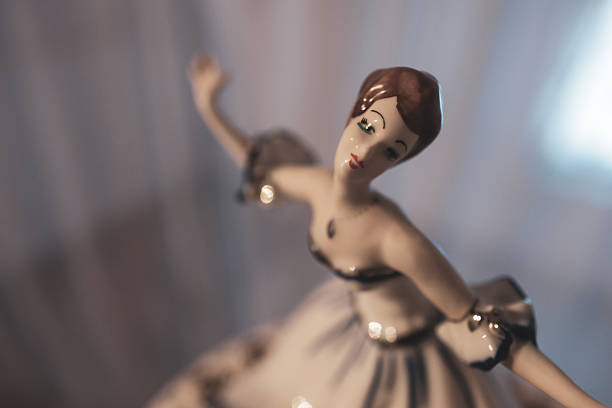 A close up of an antique baby doll in a Victorian baby carriage.