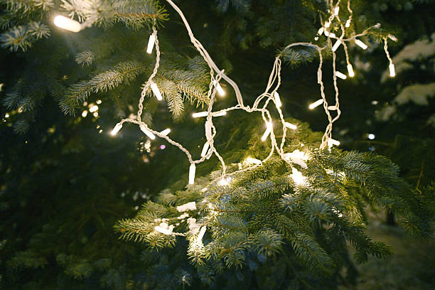 Christmas tree decorated with garland and glowing ornaments