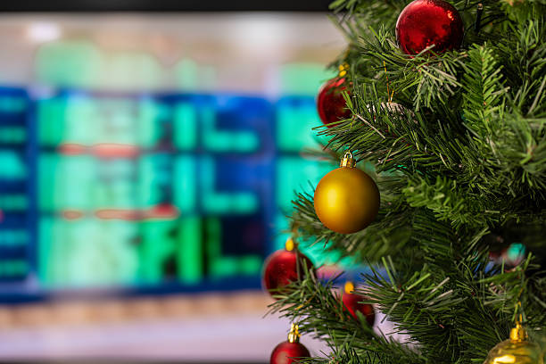 istock Christmas Tree in the foreground on a flight departures display 2238493117
