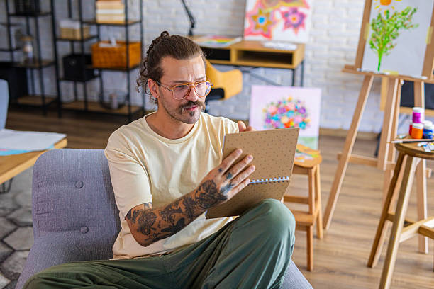 istock Focused Artist sketching ideas for a new painting at home studio 2238493549