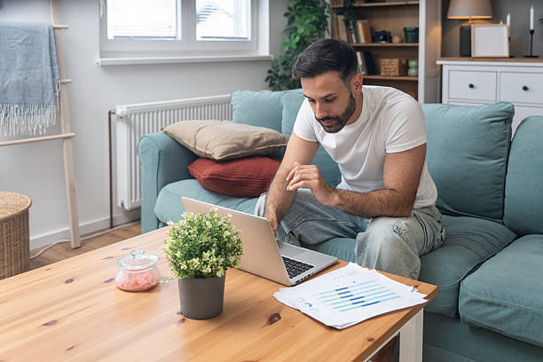 istock Young university student, freelancer business man, working at home on laptop computer, testing new innovative technology and online internet tools while sitting in home office. 2238493763