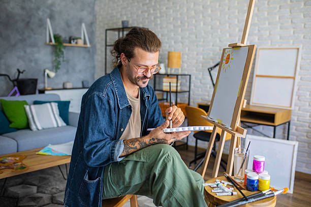 istock Painter enjoying the creative process of painting on canvas at home studio workspace 2238493886