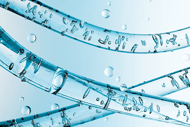 istock Transparent glass tubes with floating water bubbles on a blue background. Abstract 3D, symbolizing purity, hydration, science, cosmetics, and product technology. 2238494061