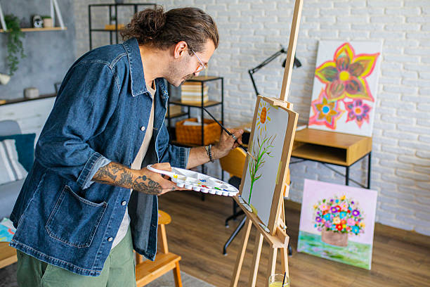 istock Painter enjoying the creative process of painting on canvas at home studio workspace 2238494126