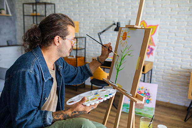 istock Painter enjoying the creative process of painting on canvas at home studio workspace 2238496925
