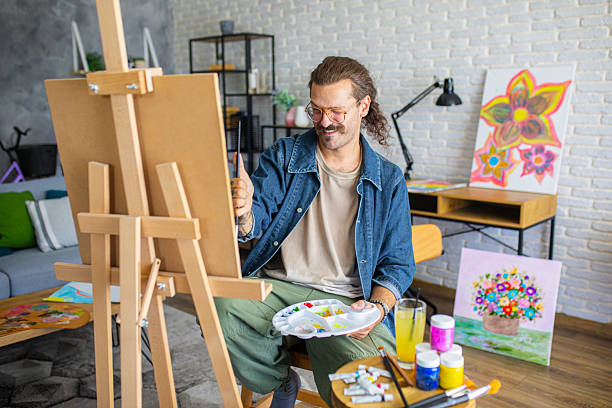 istock Painter enjoying the creative process of painting on canvas at home studio workspace 2238497001