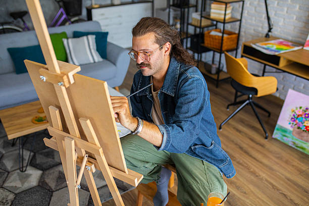 istock Painter enjoying the creative process of painting on canvas at home studio workspace 2238497170