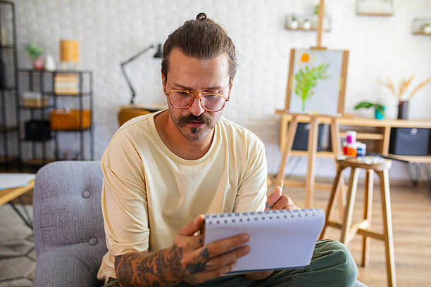 istock Focused Artist sketching ideas for a new painting at home studio 2238497410