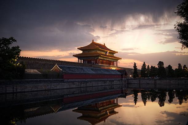Last rays of sun hit to  ancient north gate of Forbidden city and same time rain closing which makes view very dramatic and extraordinary. North gate of Forbidden city is famous because very close is another ancient place called Jingshan hill. Autumn time in Beijing often bring very nice light and no polluted sky for people to enjoy weather.