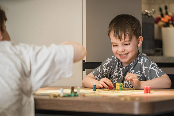 istock Happy Childs Play Board Game At The Kitchen Table 2238502844