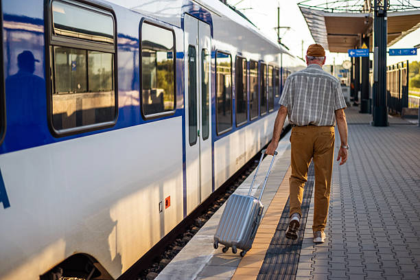 istock Senior man at railway station 2238508357