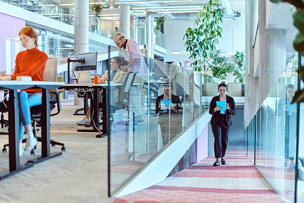 istock In a modern startup office, a diverse group of young professionals collaboratively tackles various business problems and challenges, surrounded by their engaged colleagues, fostering innovation and productivity 2238509088