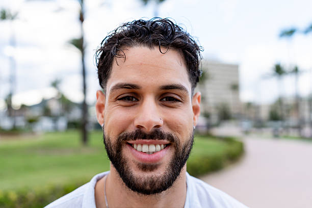 istock Young adult man with beard smiling looking at camera 2238509299