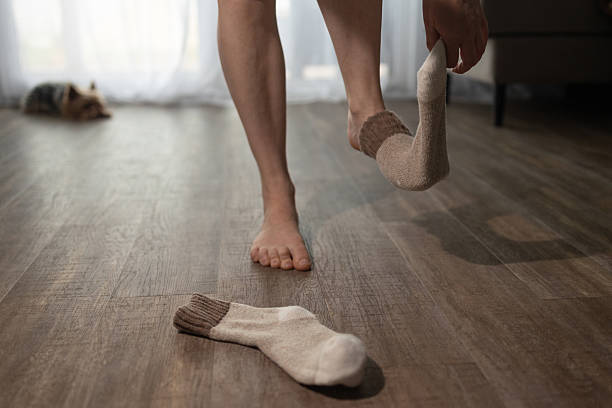 istock Feet Taking off Warm Socks Inside House With Underfloor Heating 2238509336