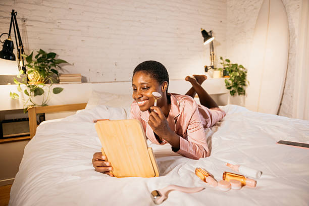 istock Woman enjoying self-care routine with jade roller in bed 2238509531