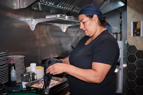 istock Female chef preparing food in commercial kitchen 2238512165
