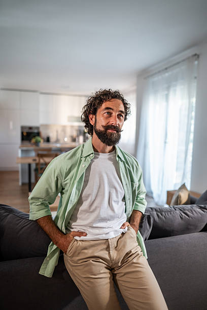 istock Man standing in light living room thinking 2238513038