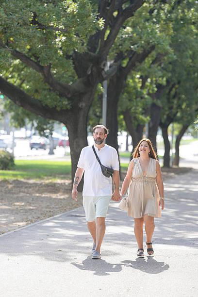 istock A man and woman are walking down a sidewalk 2238513713