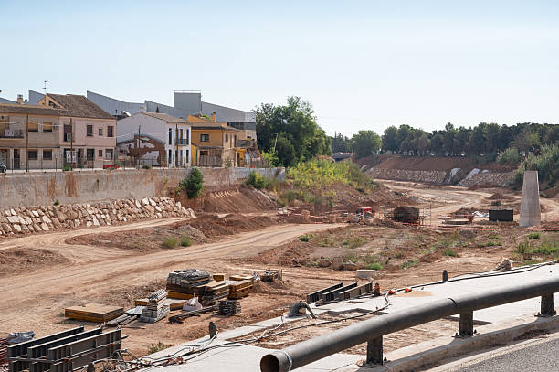 Reconstruction work occurring in the Barranco del Poyo riverbed, showing a flood recovery project