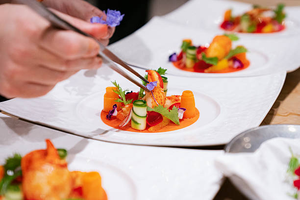istock Chef Plating Fine Dining Dish with Edible Flowers and Lobster 2238517055