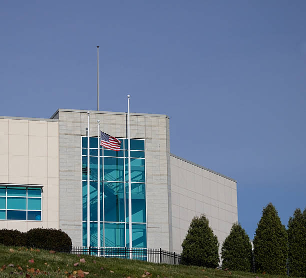 istock American Flag Above White American Building Or Office Building. 2238518967