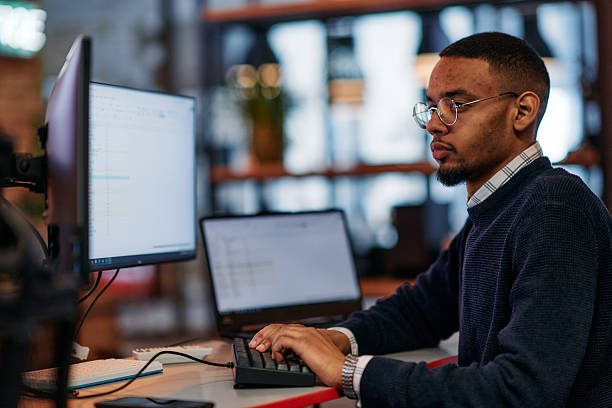 istock Focused Excellence: An African American Programmer Tackles Challenges in a Modern Office Environment. 2238519353