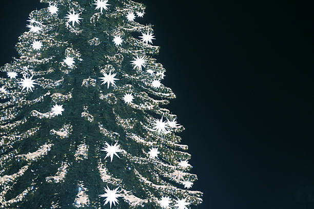 Christmas tree decorated with garland and glowing ornaments