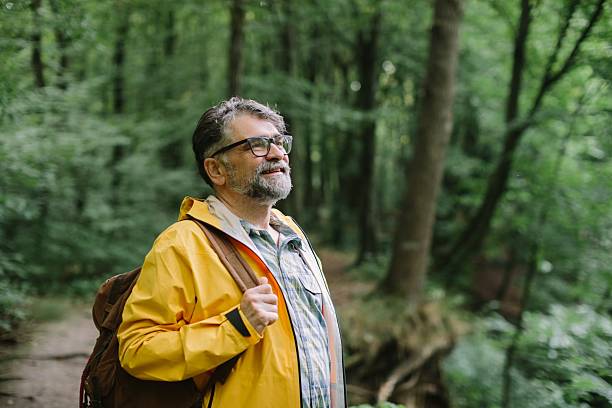 istock Man hiking in forest, enjoying nature journey 2238522390