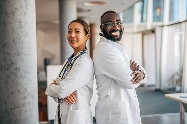 istock Diverse doctors standing back to back smiling confident in healthcare 2238523740