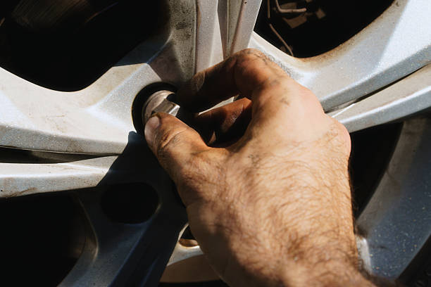 istock Changing a tire on a car in a garage during the afternoon while focused on the wheel 2238523832