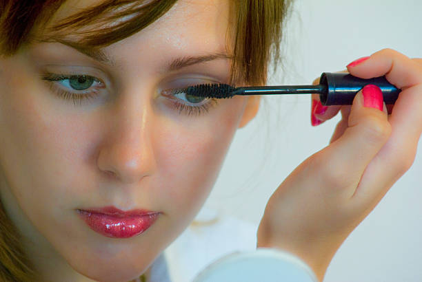 istock Young Woman Applying Makeup 2238523914